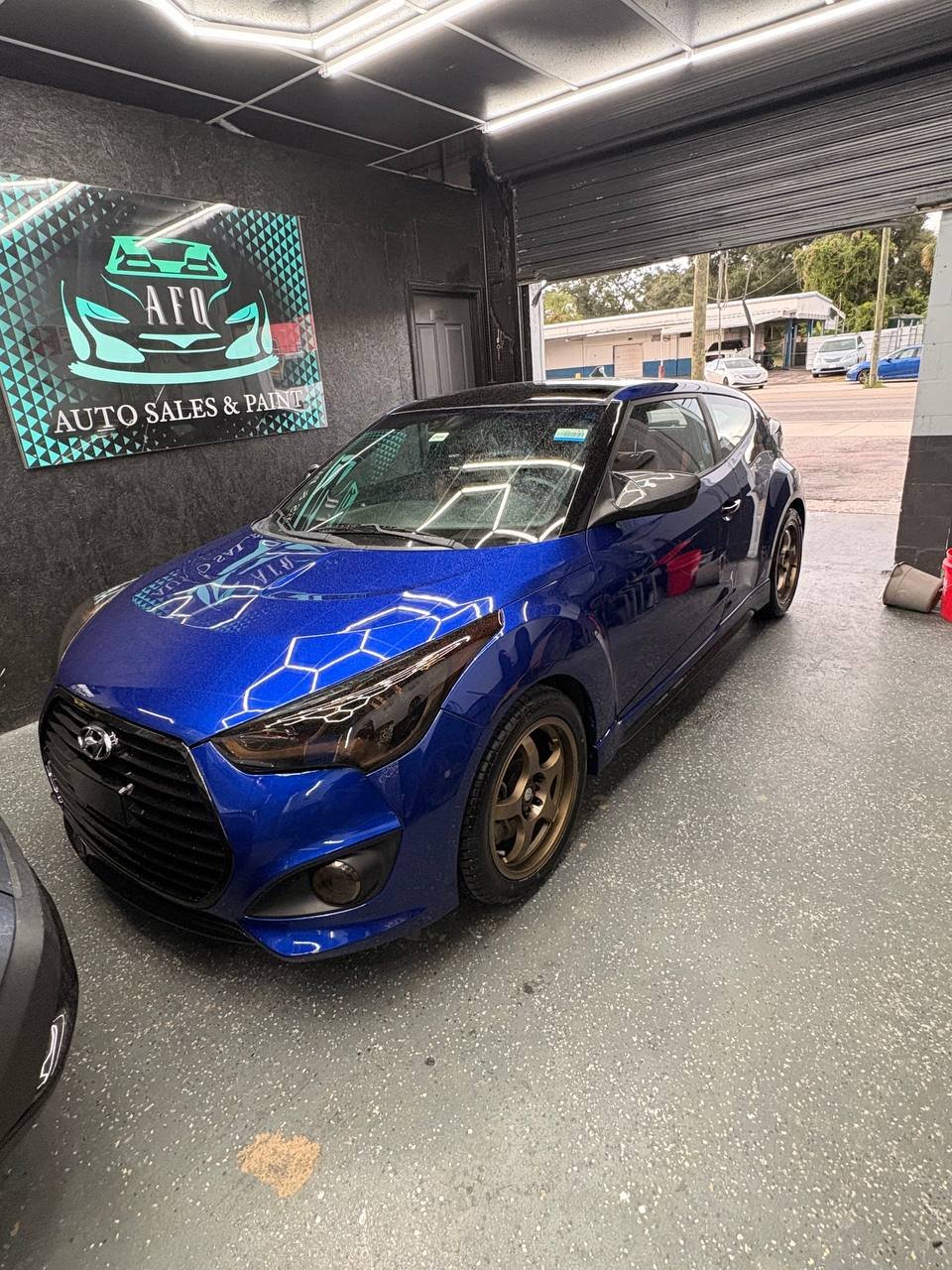 Blue vehicle after paint refinishing at AFQ Auto Sales and Paint in Tampa